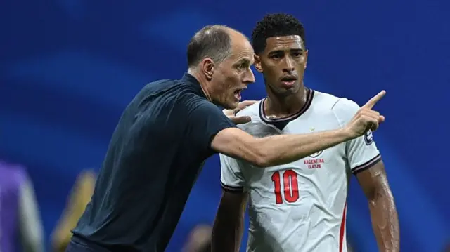 Thomas Tuchel, Manager of England, speaks with Jude Bellingham #10 of England during the FIFA World Cup 2026 Semi Final match between England and Argentina at Atlanta Stadium on July 15, 2026 in Atlanta, Georgia
