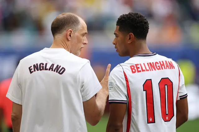 Thomas Tuchel, Head Coach of England speaks with Jude Bellingham