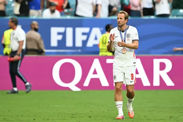 Harry Kane reacts with his medal