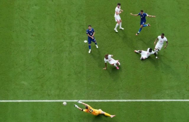 England's Dean Henderson makes a save from France's Kylian Mbappe