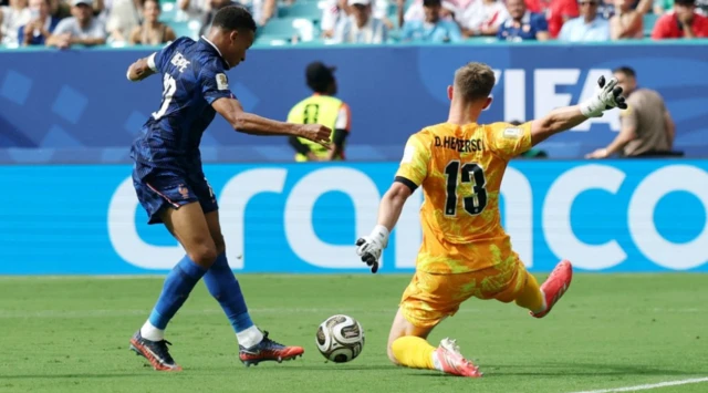 France's Kylian Mbappe in action with England's Dean Henderson R