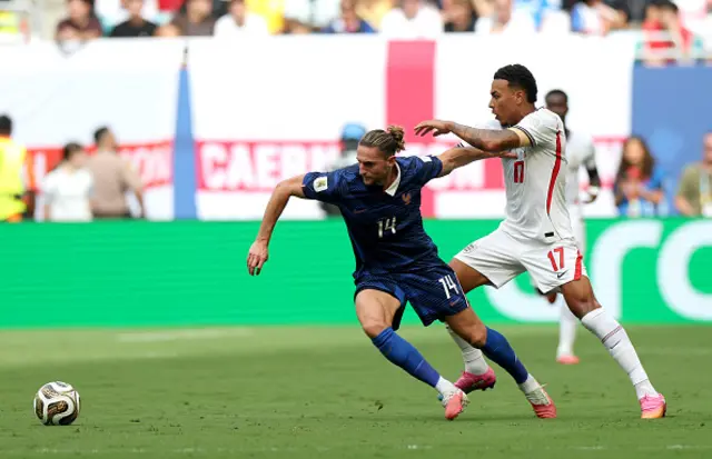 Adrien Rabiot #14 of France is challenged by Morgan Rogers