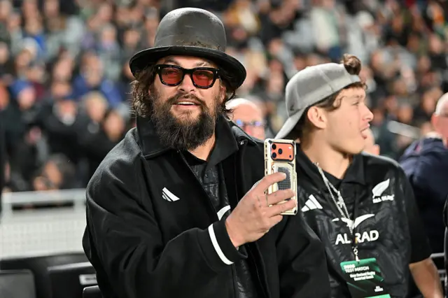New Zealand fan takes a picture on his phone during the Nations Championship match between New Zealand All Blacks and Ireland at Eden Park