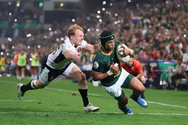 Kurt-Lee Arendse of South Africa goes past Blair Murray of Wales to score his team's sixth try