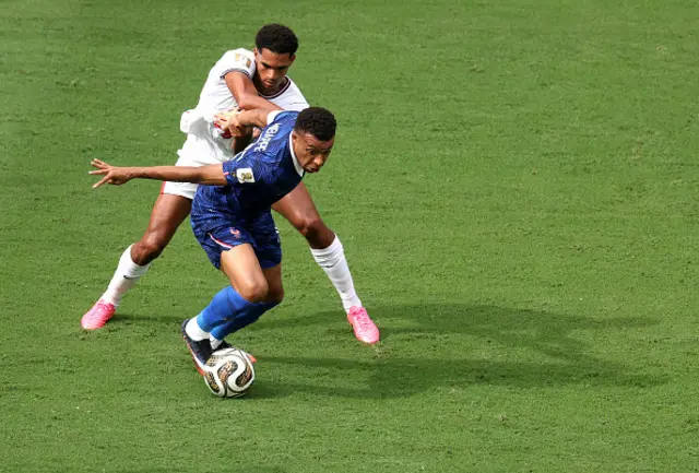 Kylian Mbappe #10 of France controls the ball against Jarell Quansah