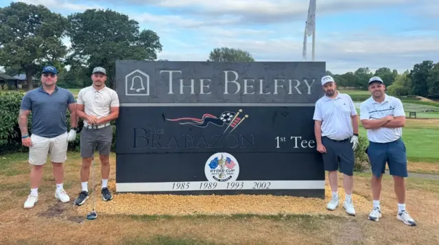 Four guys by The Belfry sign