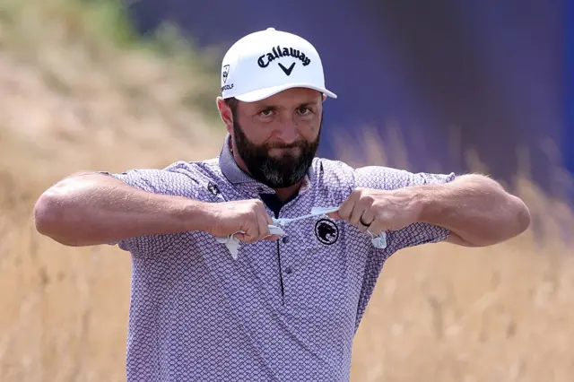 Jon Rahm tears his glove in half