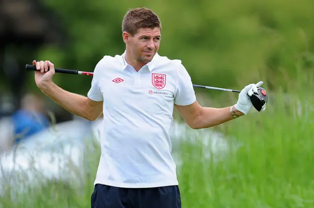 Steven Gerrard holding a golf club