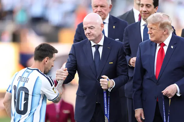 Lionel Messi #10 of Argentina receives his runner-up medal from FIFA President Gianni Infantino and U.S. President Donald Trump