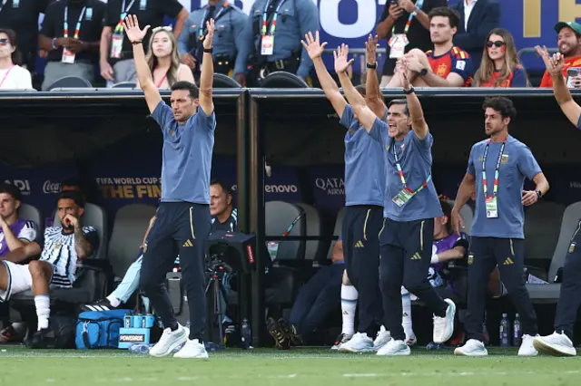 Argentina's head coach Lionel Scaloni (L) and members of the staff react