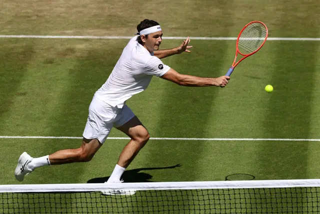 Taylor Fritz of United States plays a backhand volley