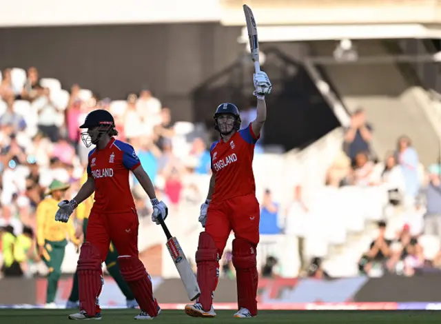 England's captain Nat Sciver-Brunt (R) celebrates their half-century