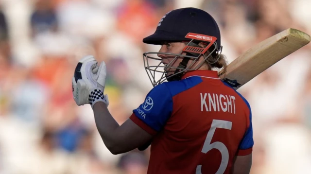 Heather Knight looks on