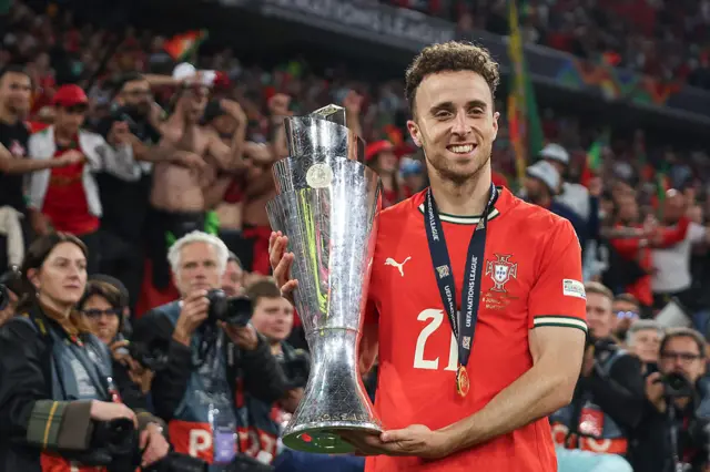 Diogo Jota of Portugal poses for a photograph with the Nations League trophy