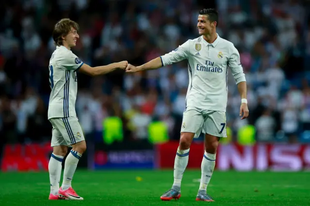 Cristiano Ronaldo (R) of Real Madrid CF clashes knuckles with his teammate Luka Modric