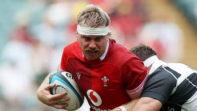 Aaron Wainwright carries the ball for Wales against the Barbarians