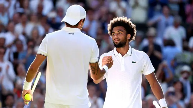 : Matteo Berrettini of Italy Arthur Fils shake hands