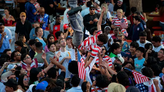 A USA fan is thrown into the air at San Pedro Square Market
