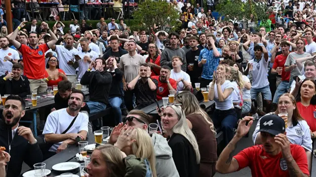 England fans watch the DR Congo game in a pub in Manchester