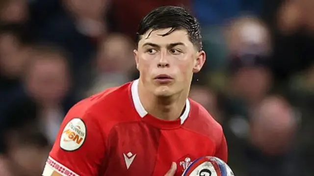 Louis Rees-Zammit playing for Wales in red