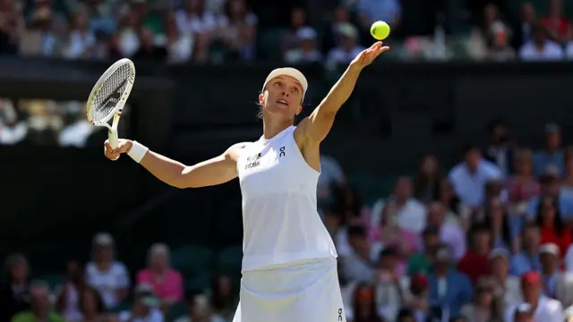 Iga Swiatek of Poland serves