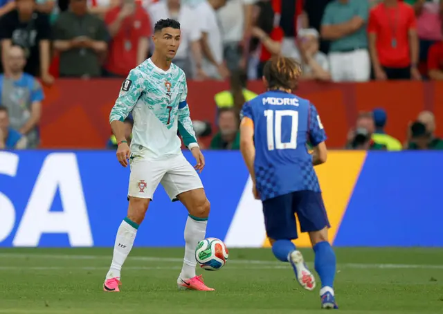 Cristiano Ronaldo and Croatia's midfielder #10 Luka Modric fight for the ball