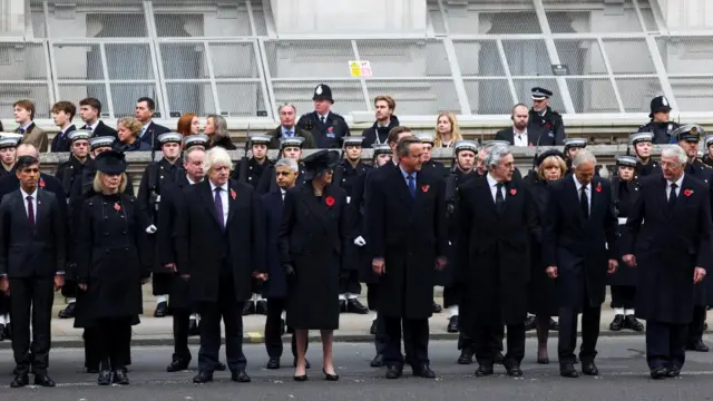 Former prime ministers stood in a line with military personnel behind them