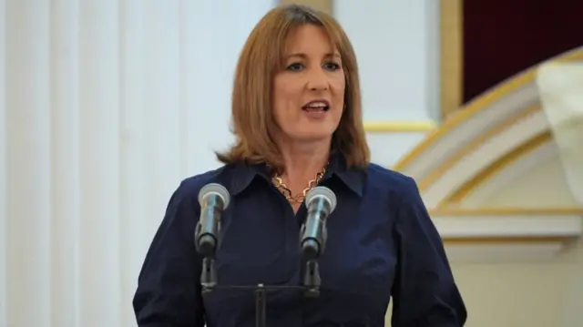 Rachel Reeves mid speech in a blue dress