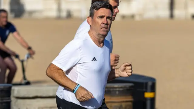 Burnham running in a white t shirt