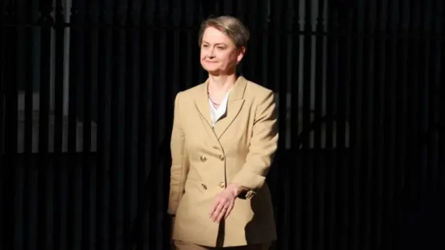Cooper walks up Downing Street smiling