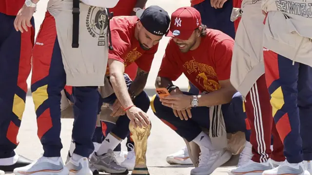 Alex Baena touches the World Cup trophy