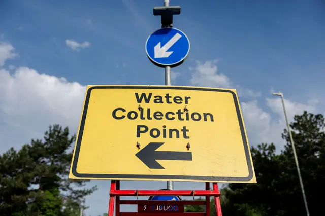 A yellow sign which says Water Collection Point.