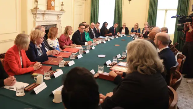 Andy Burnham, UK prime minister, center, with ministers during his first cabinet meeting inside 10 Downing Street in London, UK, on Tuesday, July 21, 2026