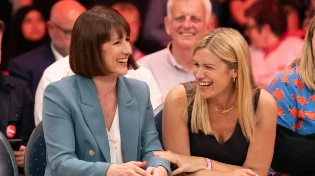 Rachel Reeves (left) and her sister Ellie seated and laugh together