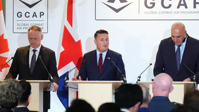 Streeting stands with Canadian Defence Minister David McGuinty and Italian Defence Minister Guido Crosetto while giving a news conference