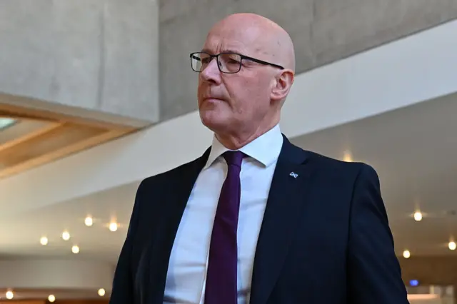 First Minister John Swinney on the way to First Minister's Questions in the Scottish Parliament