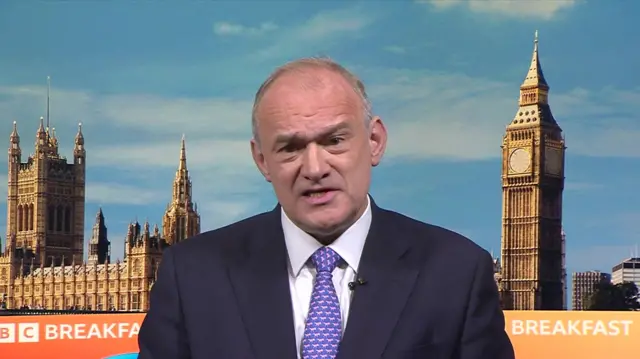 Ed Davey sits in front of the BBC Breakfast background