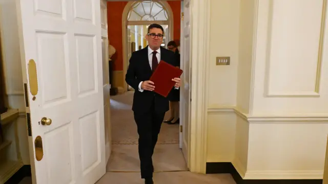 Andy Burnham, wearing a dark suit, walks for his first Cabinet meeting at No 10.