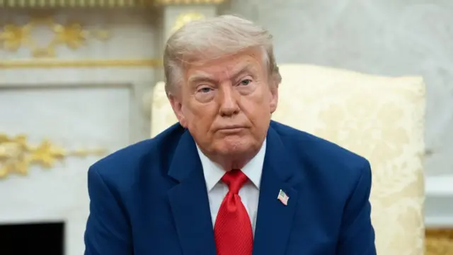 A file photo of Trump sitting in the Oval Office