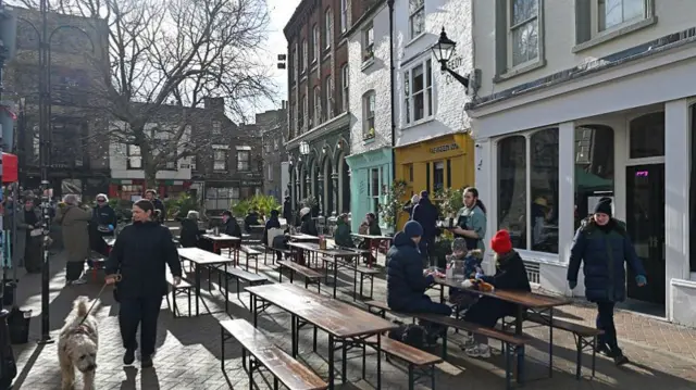 Tables are set up outside of shops and restuarants