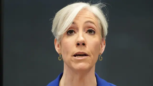 A headshot of Daisy Cooper mid-speaking