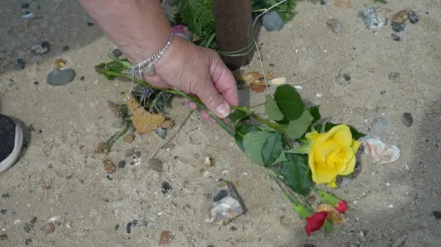 Yellow rose being put to rest at Mersea Island