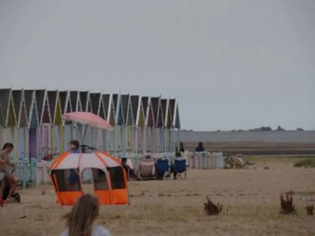 Beach huts and a a sandy beach
