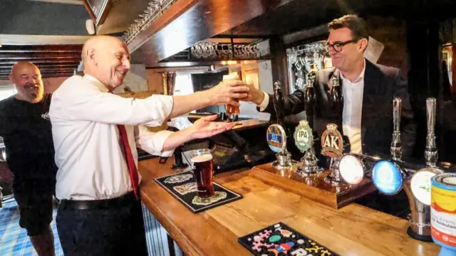 Britain's Prime Minister Andy Burnham visits the Hare Inn with Chancellor of the Exchequer John Healey, in Harlow, Essex, Britain, July 23, 2026.