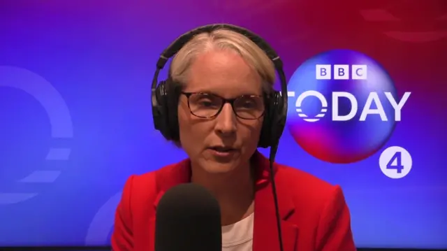 Emma Reynolds wears a red jacket and sits at a microphone in front of the Today programme logo
