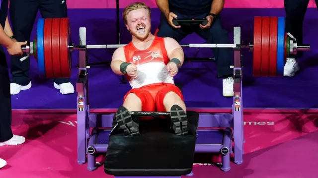 Mark Swan, wearing his team England powerlifting suit, smiling after completing his lift at the Glasgow Commonwealth Games 2026