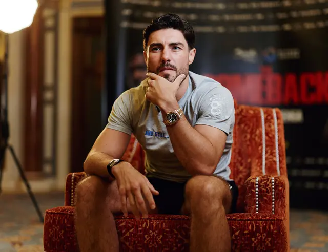 Josh Kelly with his hand on his chin looking tentative