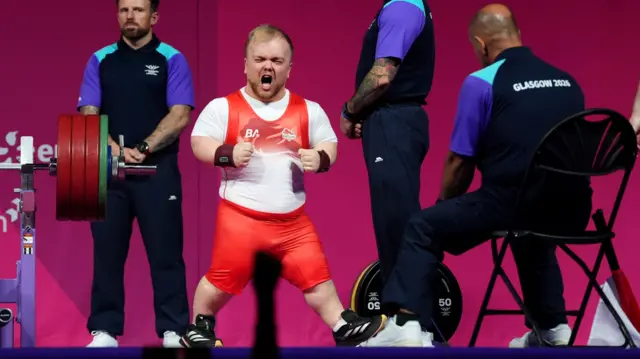 Matthew Harding celebrates his lift in his England powerlifting kit during the Commonwealth Games in Glasgow