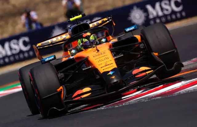 McLaren's Lando Norris drives over a kerb during final practice for the Hungarian Grand Prix