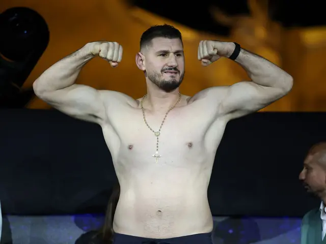 Kristian Prenga flexing his biceps